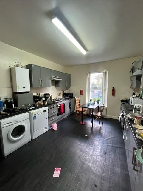 Bright shared kitchen with long run of fitted u...