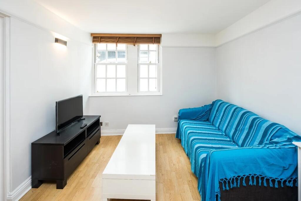 A neat and inviting living room featuring a lar...