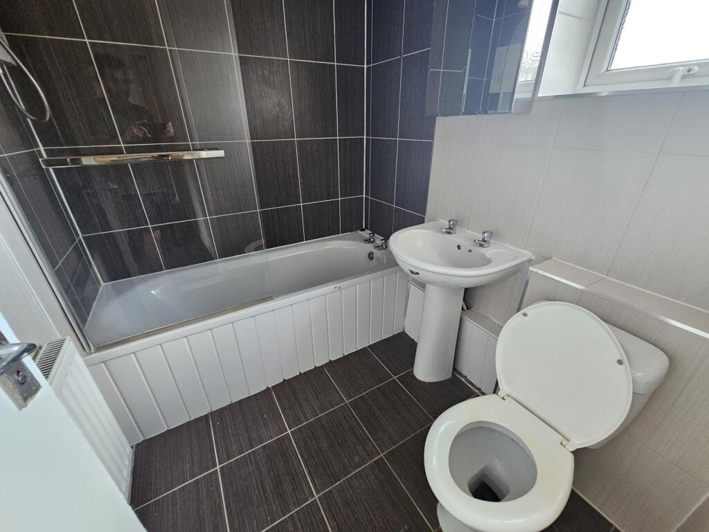 A clean and well-maintained bathroom with a bat...