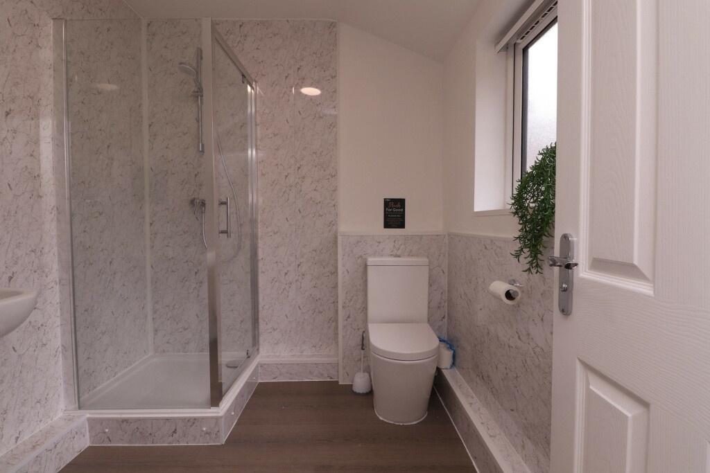 A clean and modern bathroom featuring a spaciou...