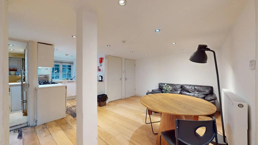 A contemporary living room featuring warm woode...