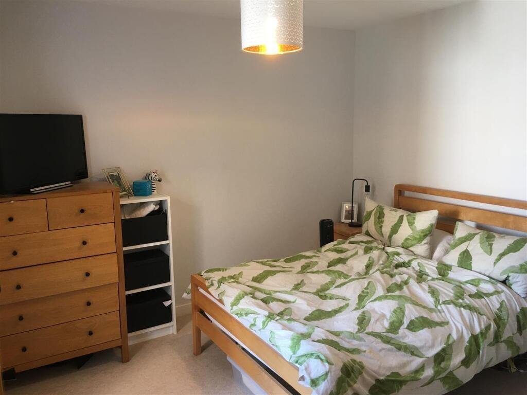 Bright and cozy double bedroom featuring a wood...