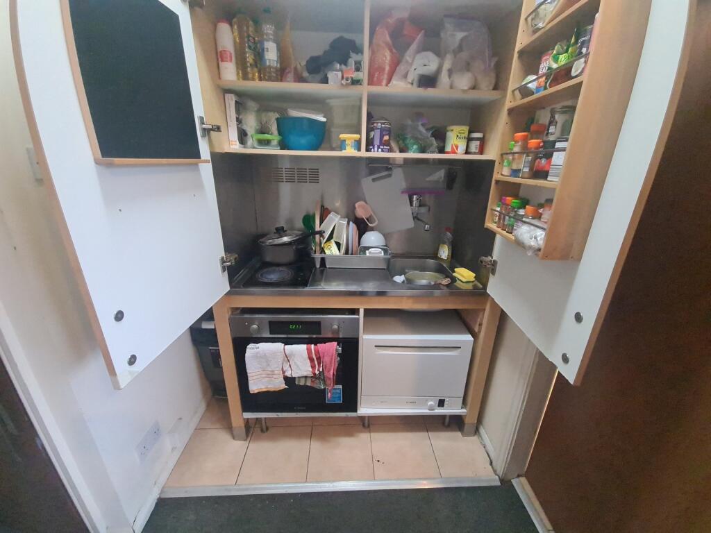 Compact and well-organized kitchen with ample s...
