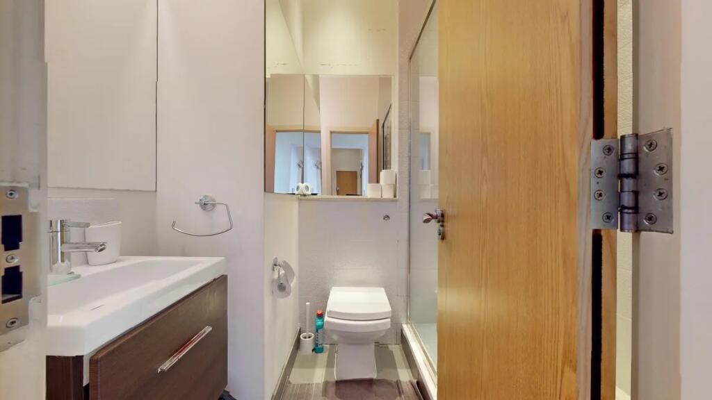 A clean and modern bathroom featuring a sleek s...