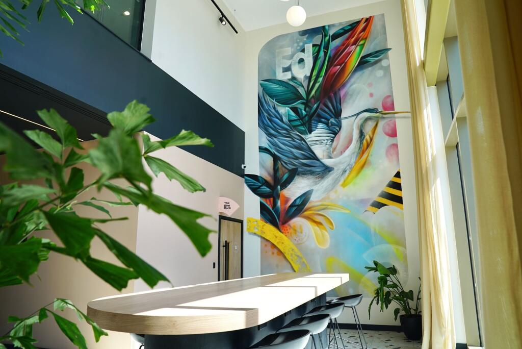 Bright and modern communal workspace featuring ...