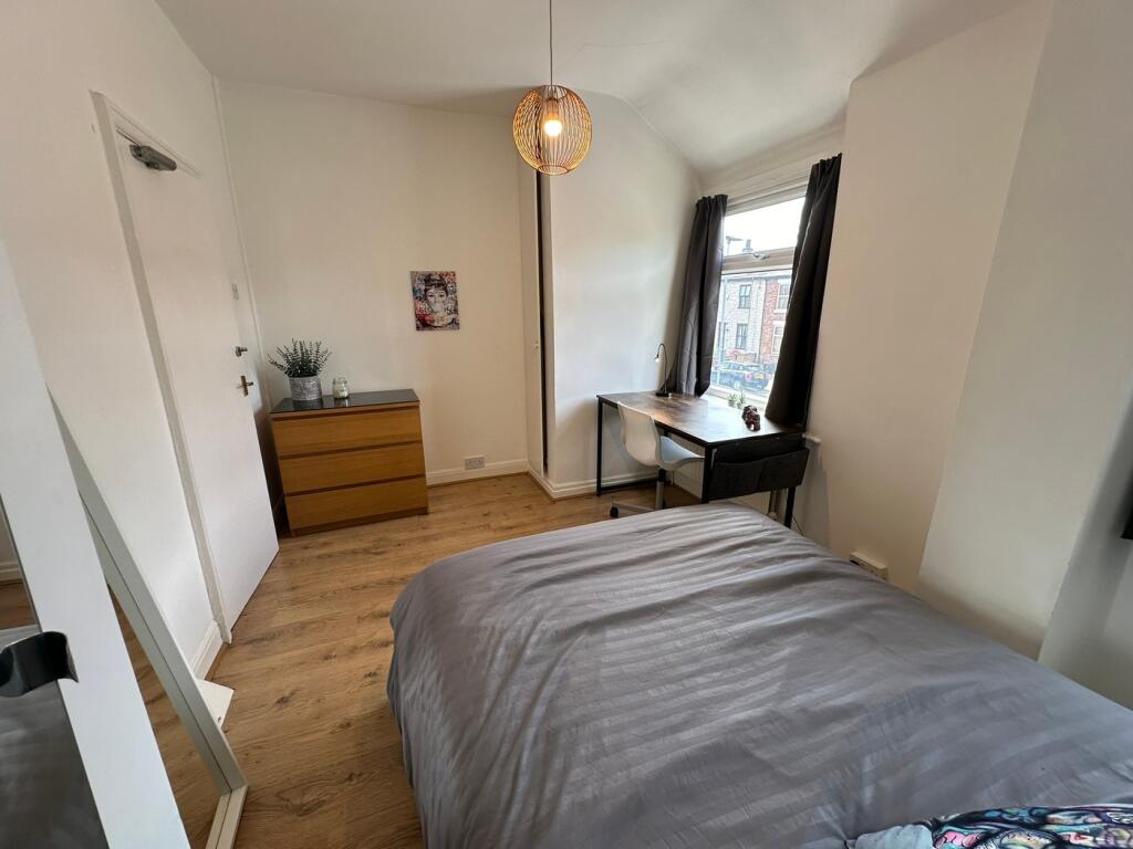 This charming double bedroom features ample nat...