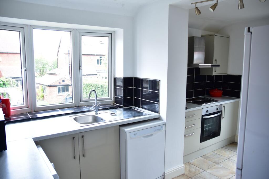 Bright and airy kitchen with large windows and ...