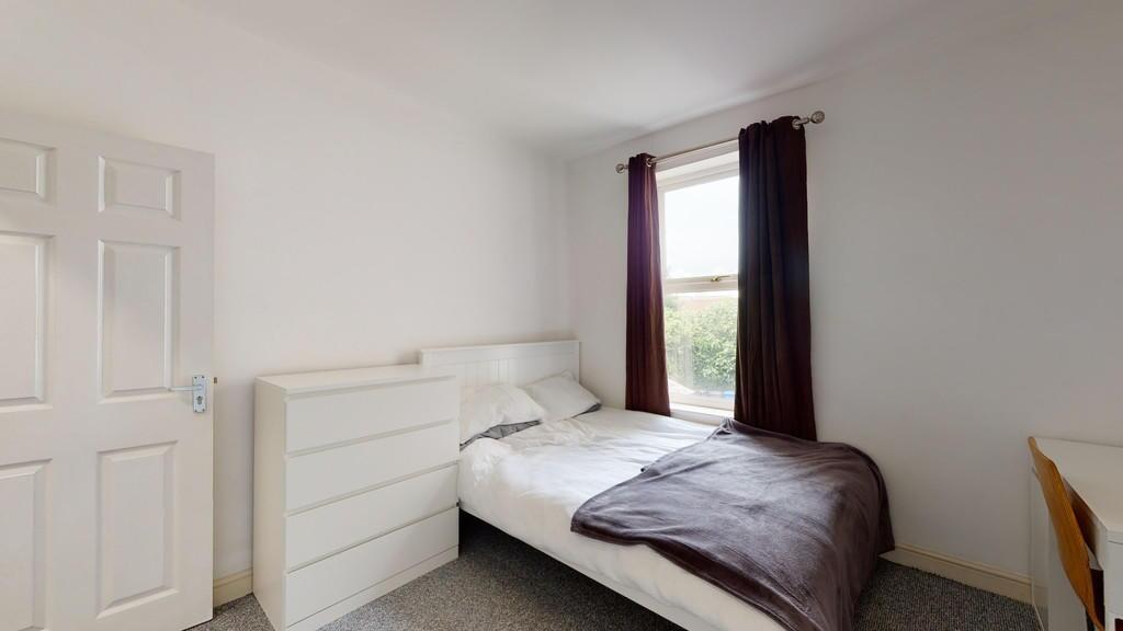 Bright and tidy single bedroom featuring a cozy...
