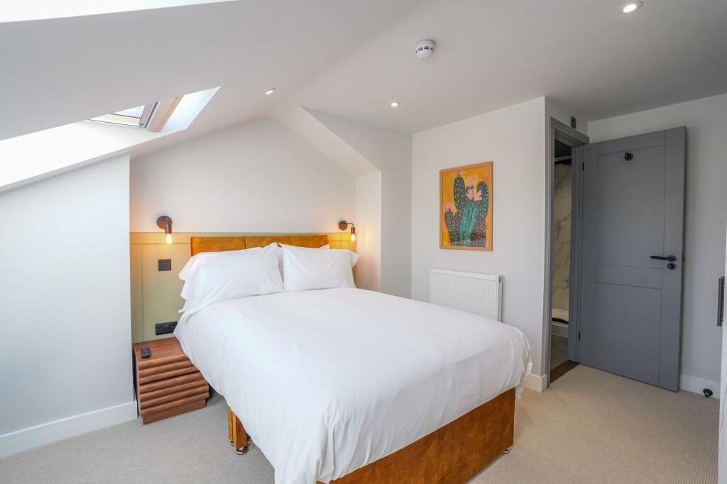 Bright and inviting double bedroom with a cozy,...