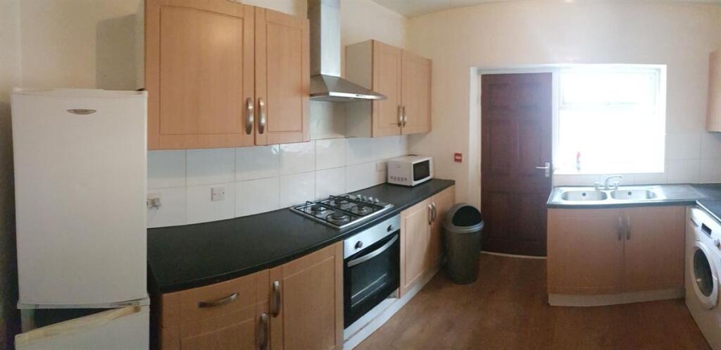 A bright and functional kitchen with ample cabi...