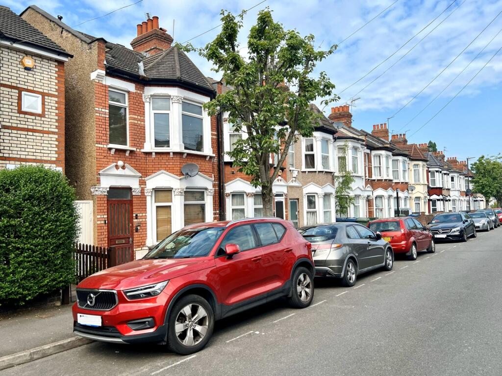 A picturesque street view featuring a row of ch...