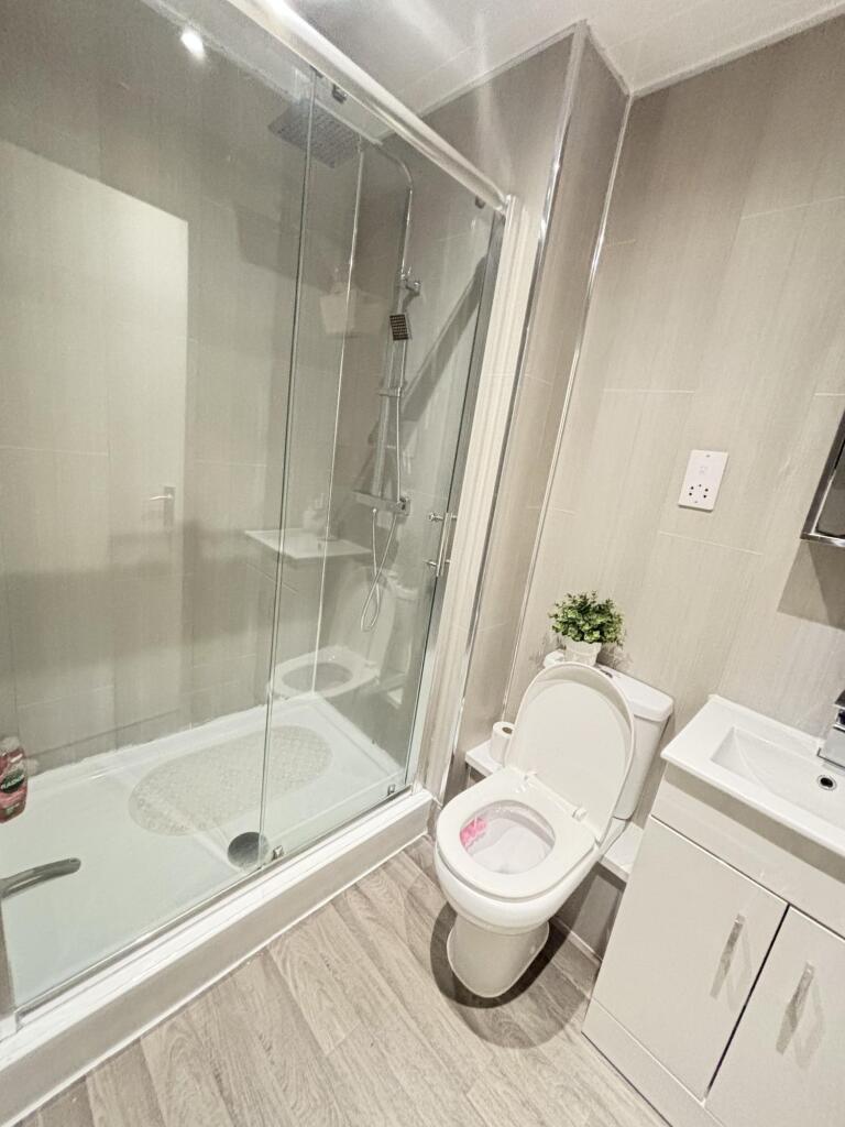 Modern bathroom featuring a spacious shower wit...