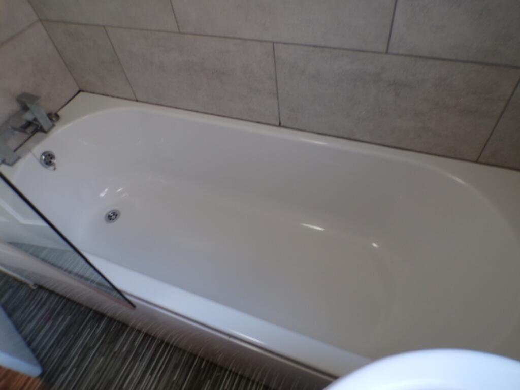 This well-maintained bathroom features a sleek ...