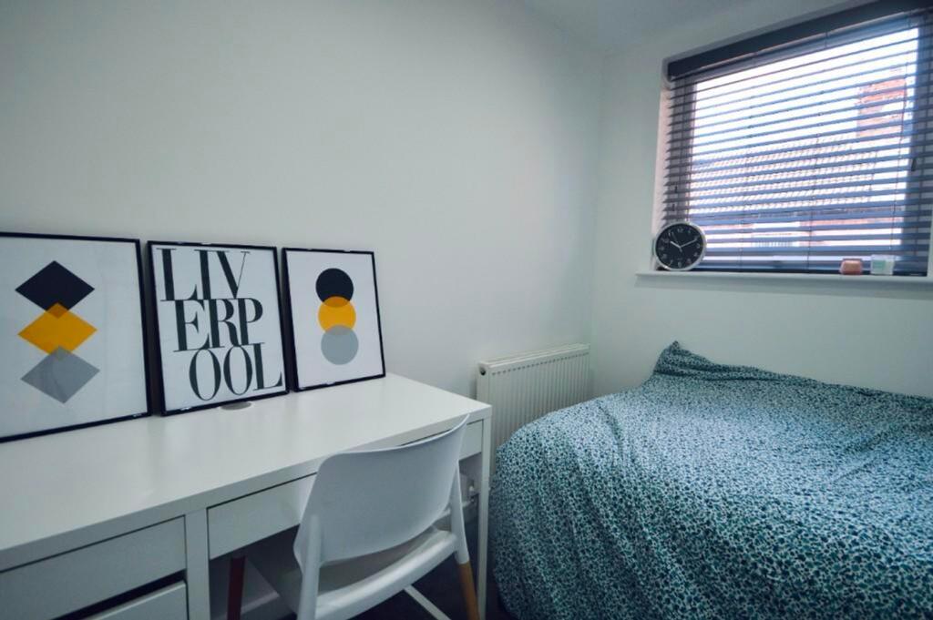 A bright and stylish double bedroom featuring m...