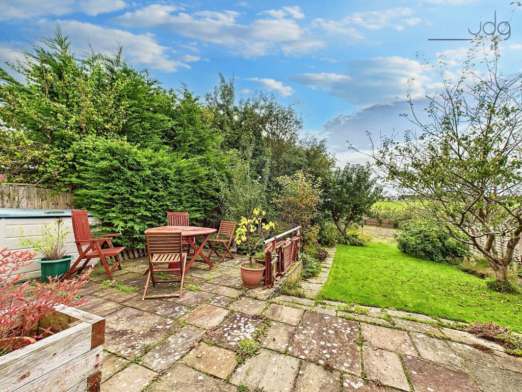 South West facing garden with prize winning pear tree, flags and lawn