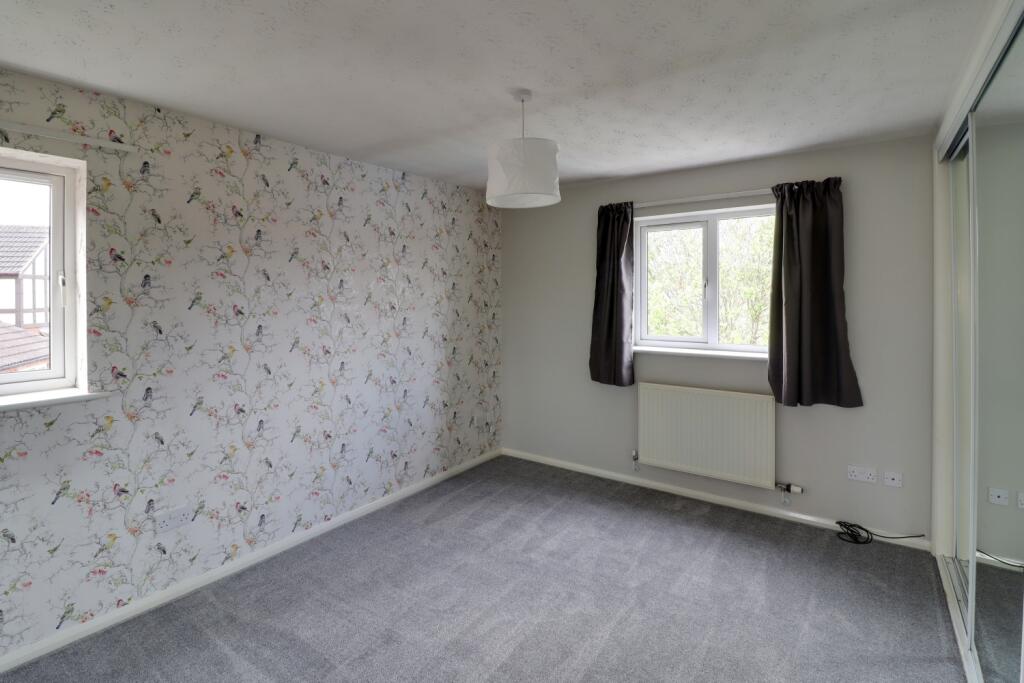 Double aspect main bedroom with 2 sets of fitted r