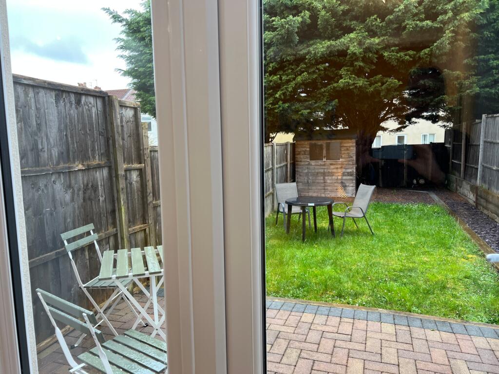 A well-maintained garden area with seating, per...