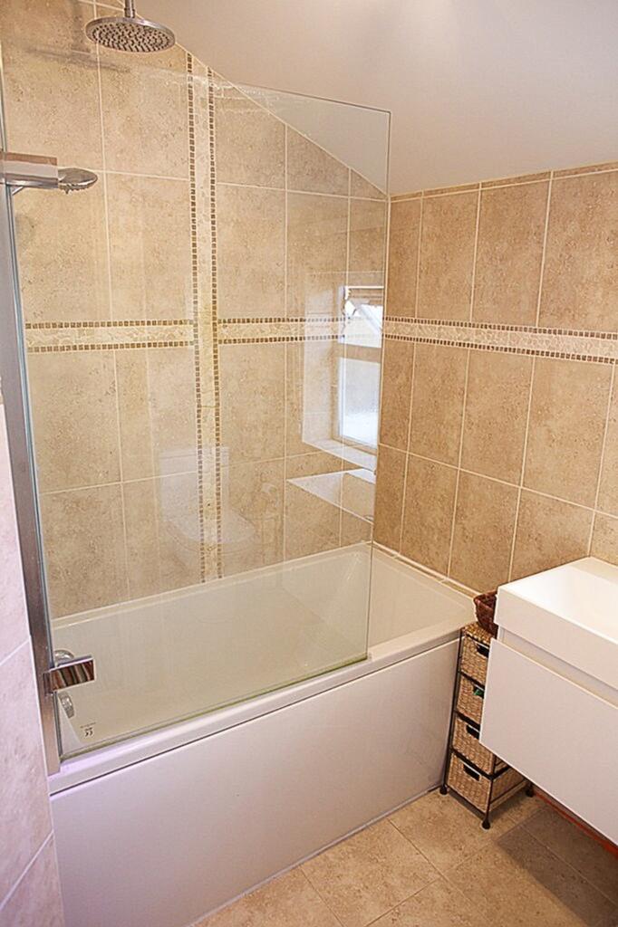 A modern bathroom suite featuring a sleek desig...