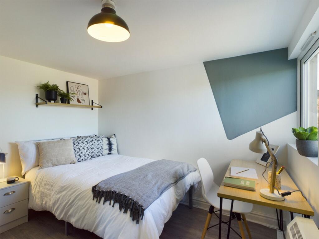 A bright and inviting double bedroom featuring ...