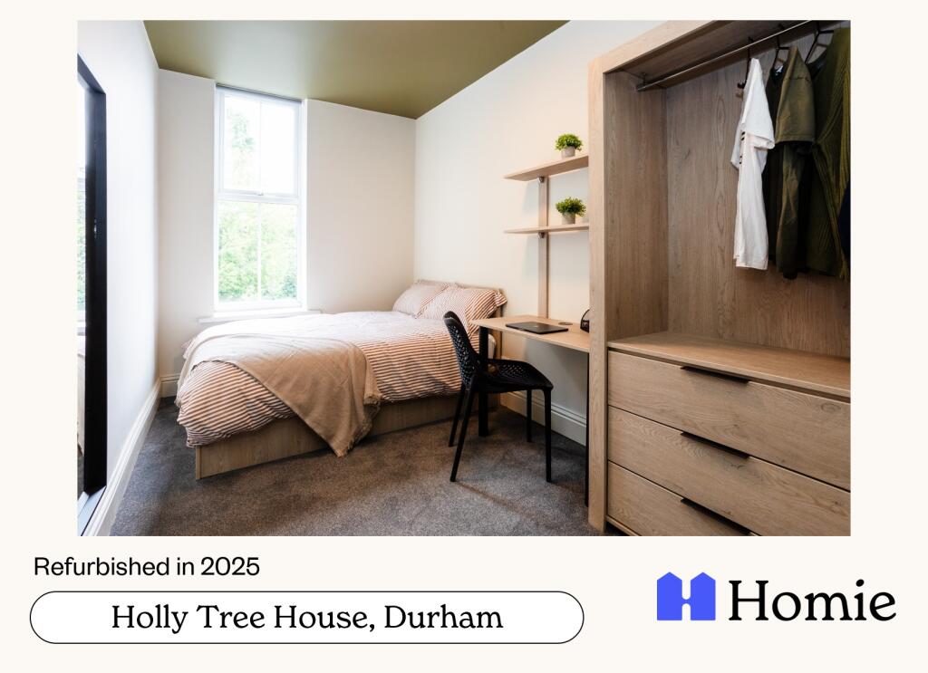 A bright and tidy bedroom with a comfortable do...