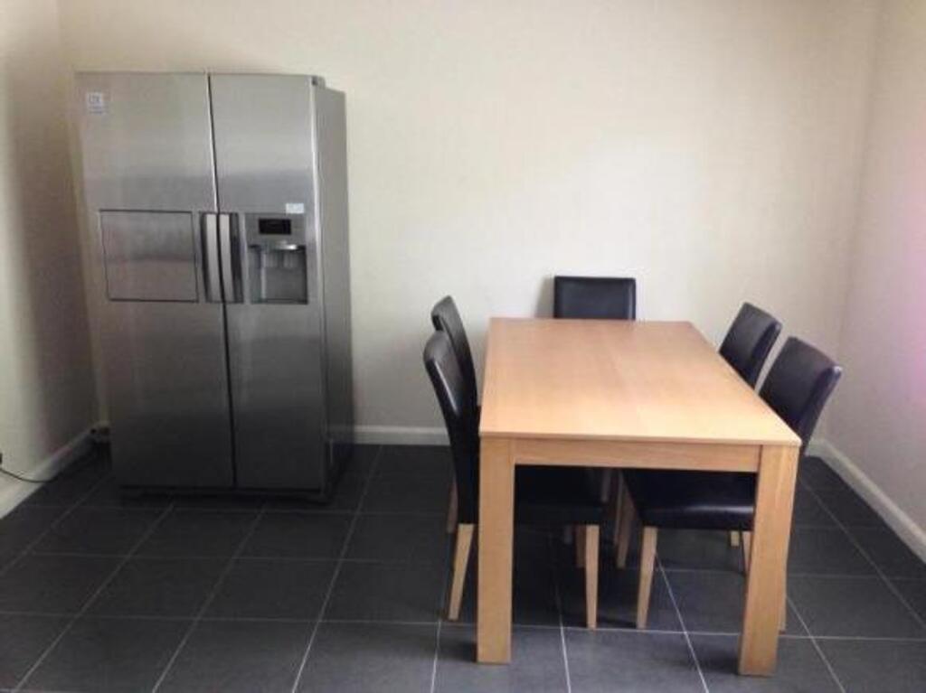 A clean and modern kitchen area with ample spac...