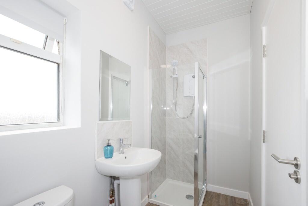 A modern bathroom featuring a sleek design with...