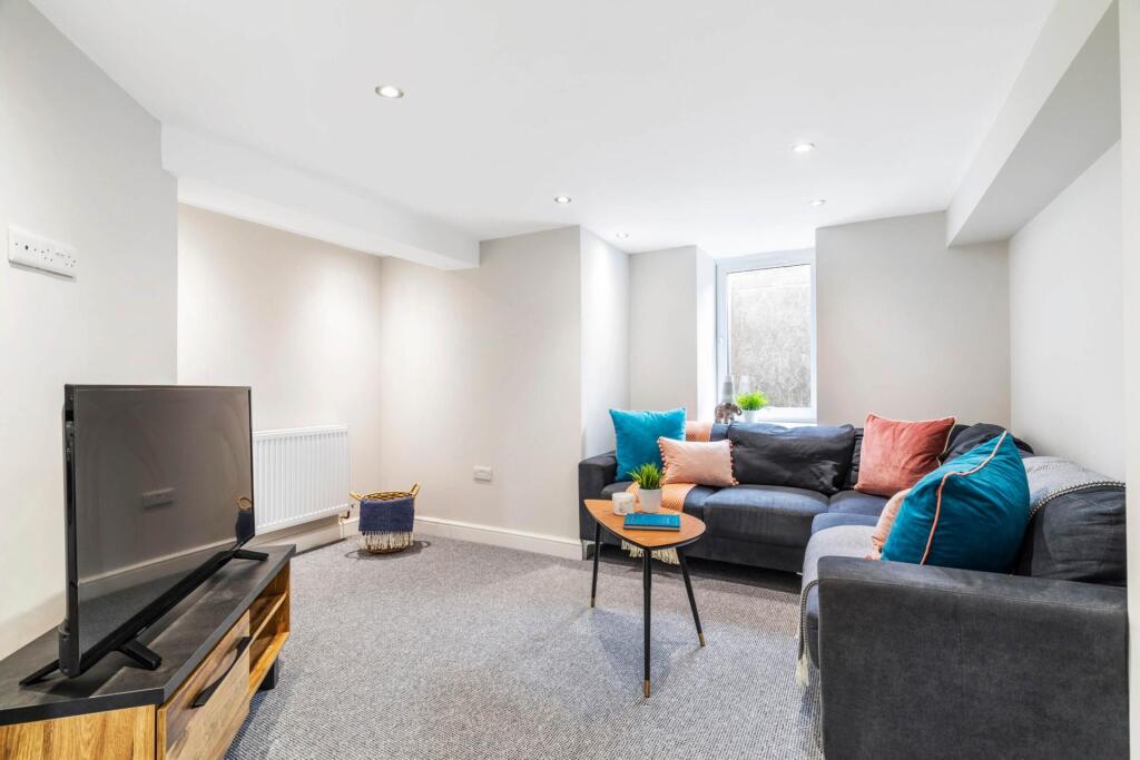 A bright and modern living room featuring comfo...