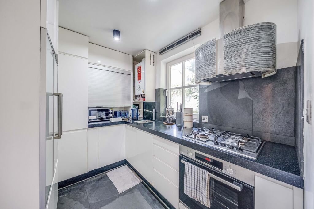 Bright and modern kitchen featuring sleek white...