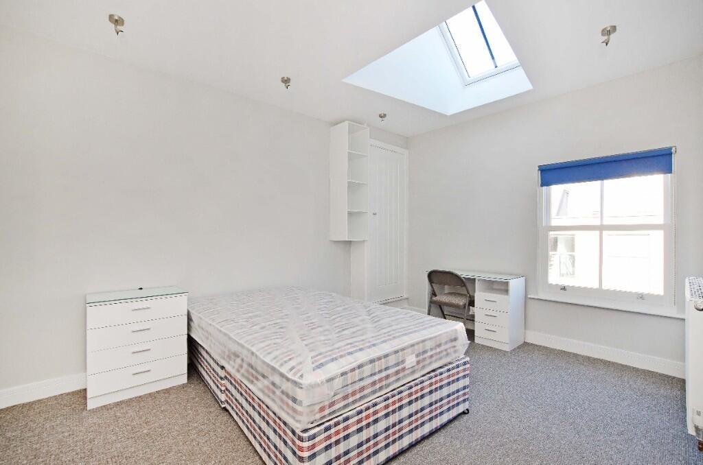 Bright and airy single bedroom featuring a comf...