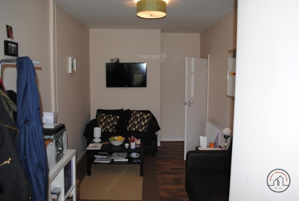 A compact, well-maintained living room featurin...