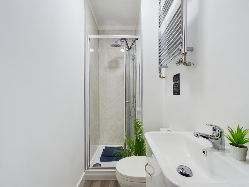 A clean, modern bathroom with a large shower ar...