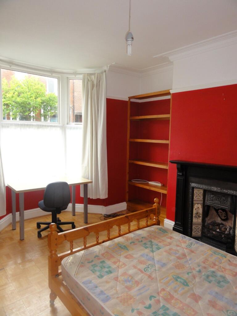 Bright and inviting bedroom with a large window...