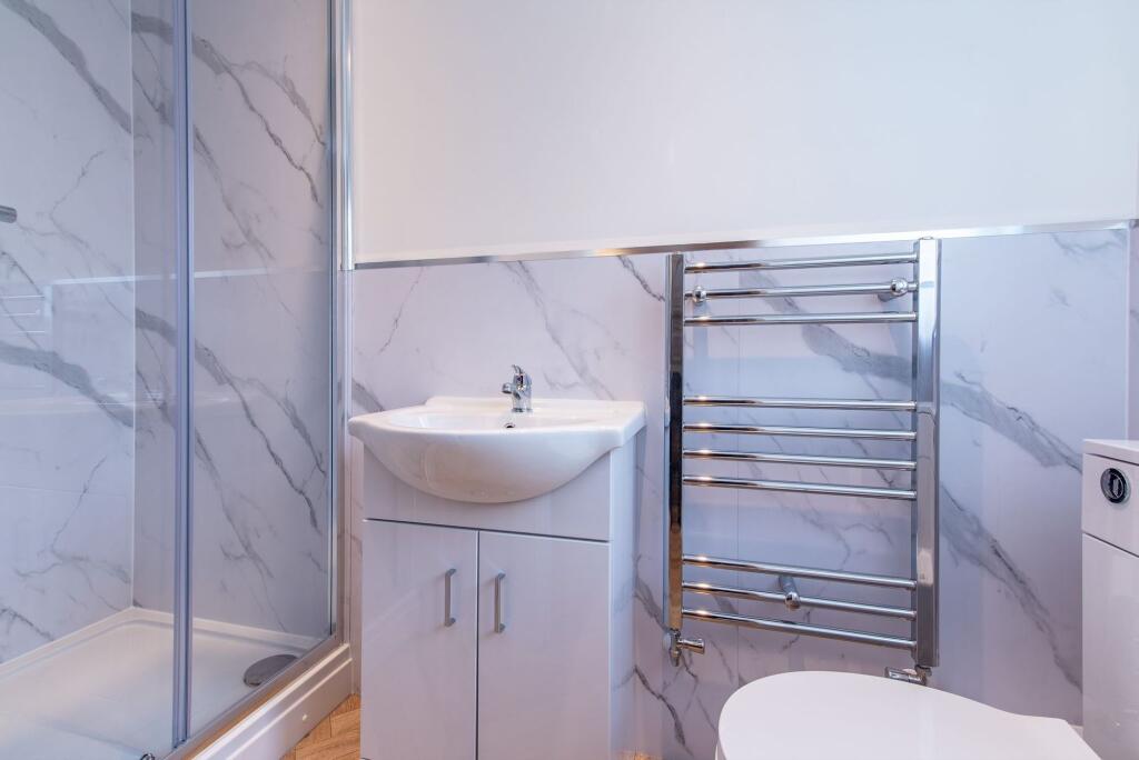 Modern bathroom with a sleek shower enclosure, ...