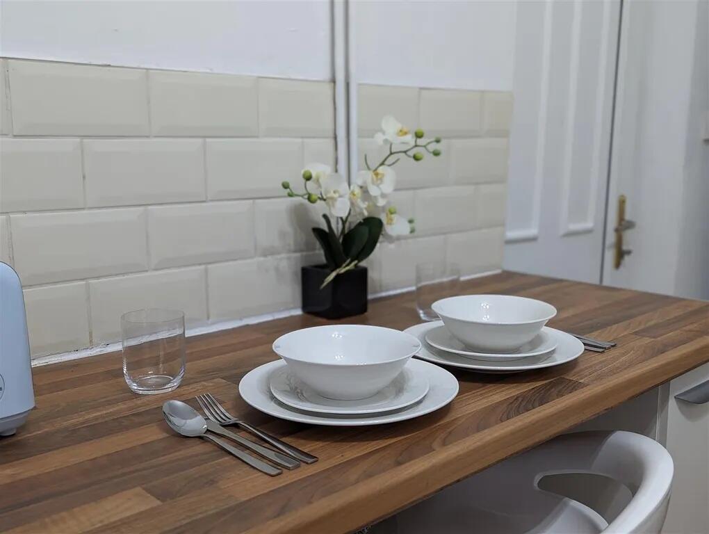 A modern, clean kitchen area with neatly arrang...