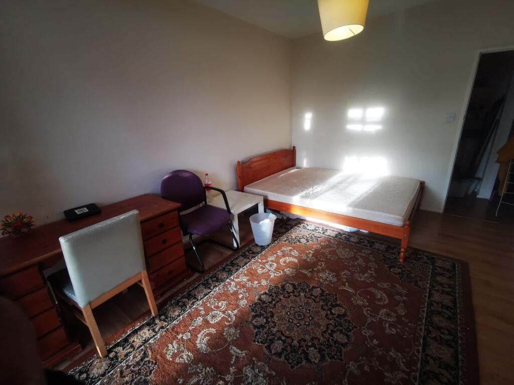 A spacious and well-lit double bedroom featurin...