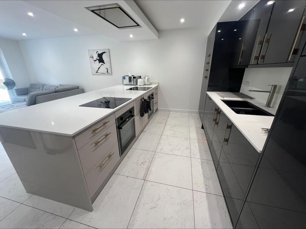 Modern kitchen with sleek black and white cabin...