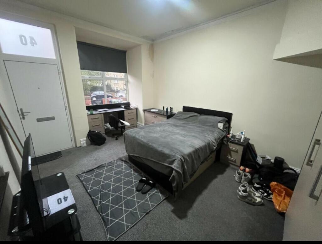A comfortable bedroom featuring a double bed, a...