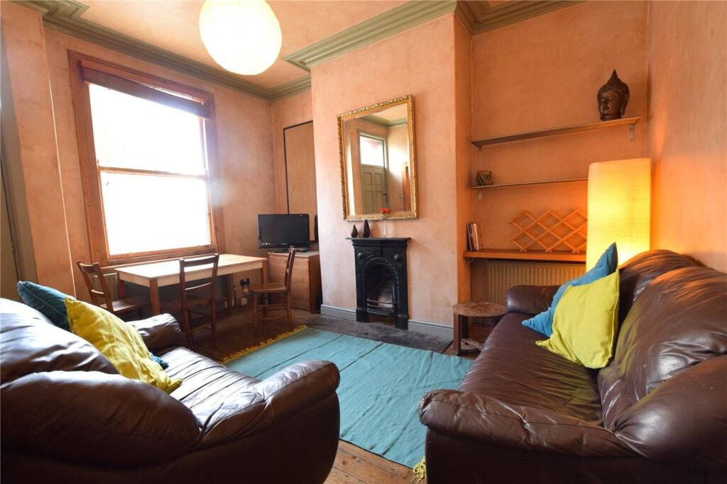 A cozy living room featuring comfortable brown ...