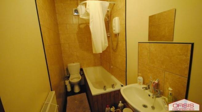 A well-maintained bathroom featuring a bath, si...