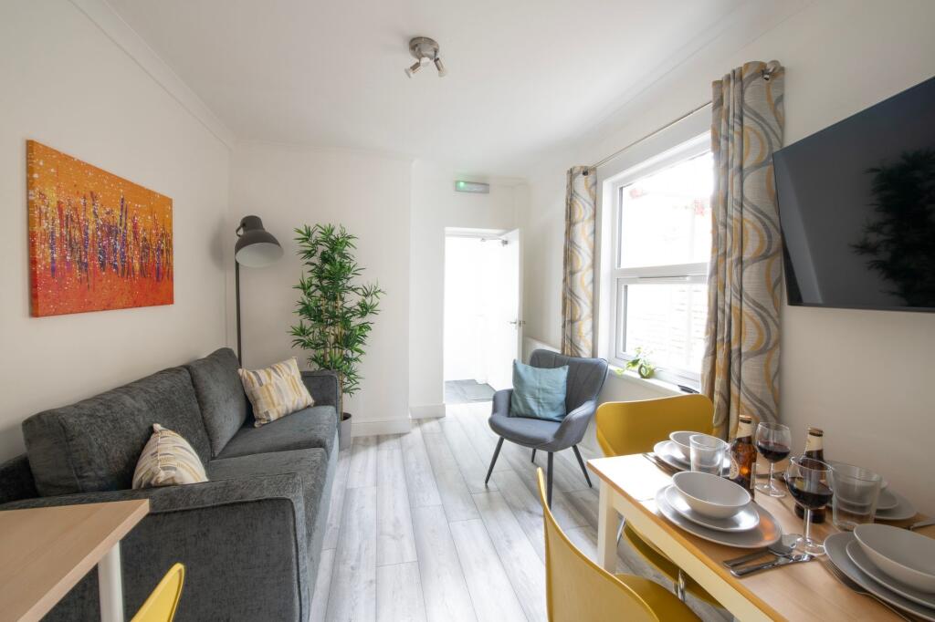 A bright and inviting living room featuring a c...