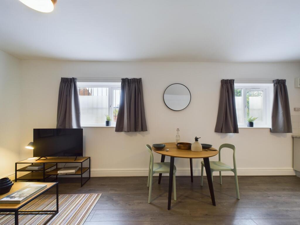 A spacious and inviting modern living room perf...