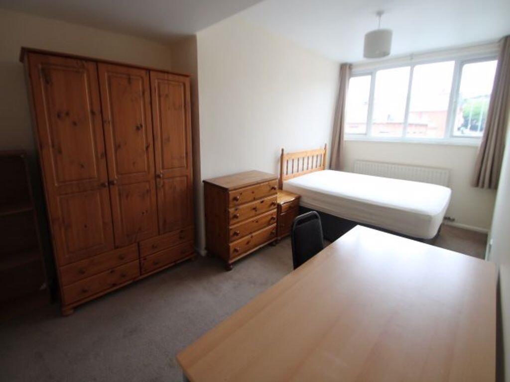A bright single bedroom featuring natural light...