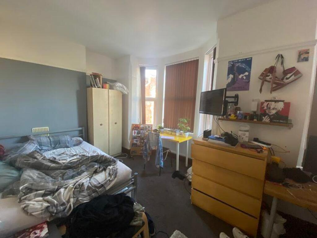 A cozy double bedroom with ample natural light,...