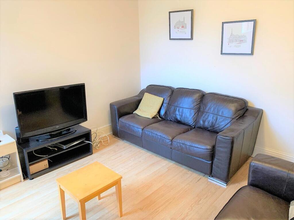 A cozy living room featuring a comfortable leat...