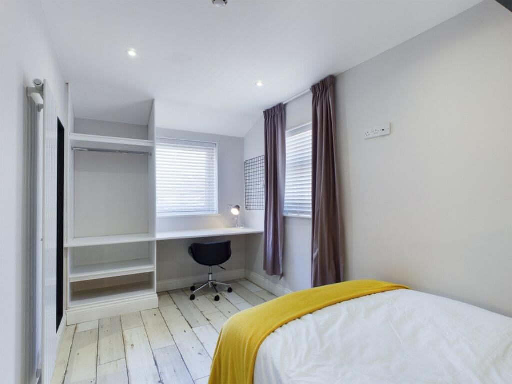 A bright and spacious double bedroom featuring ...