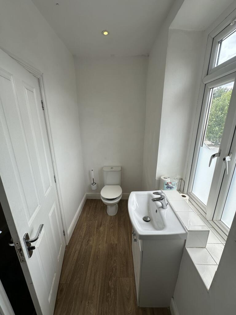 Bright and tidy single toilet space featuring m...
