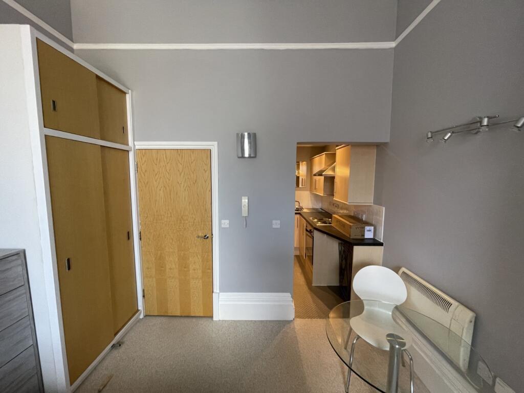 Cozy single bedroom featuring a built-in wardro...