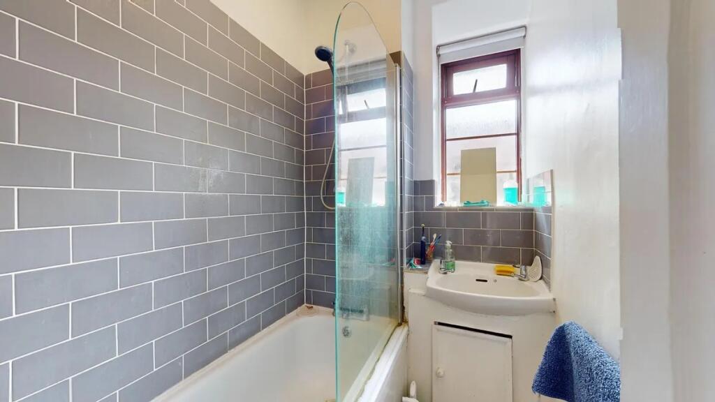 A neat and functional bathroom featuring modern...