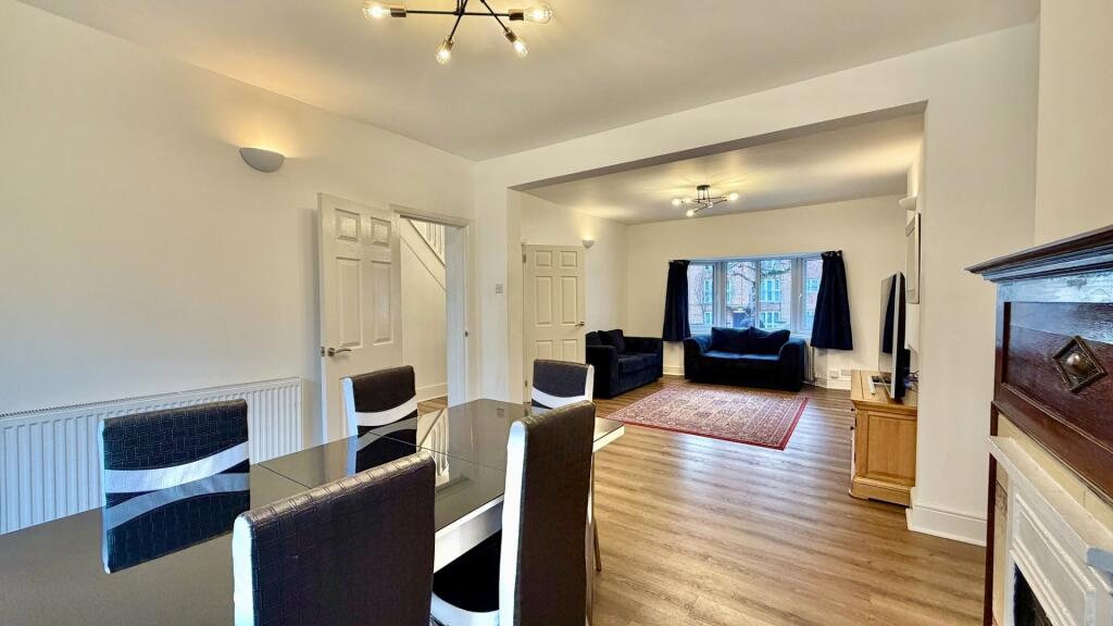 Bright, open-plan living and dining area with c...