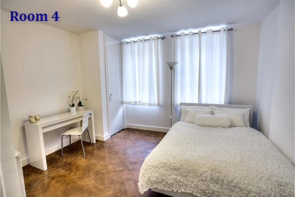 A bright and inviting double bedroom featuring ...